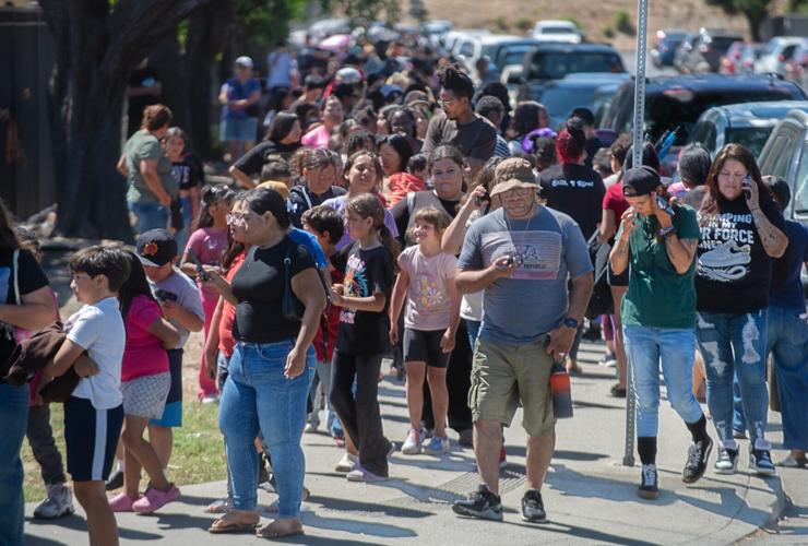 Families line up along S. Van Buren Street at Weber Avenue to get a free backpack at the Stockton Unified School District’s 4th annual backpack giveaway at the Weber Institute of Applied Sciences and Technology in downtown Stockton on Jul. 28, 2026.