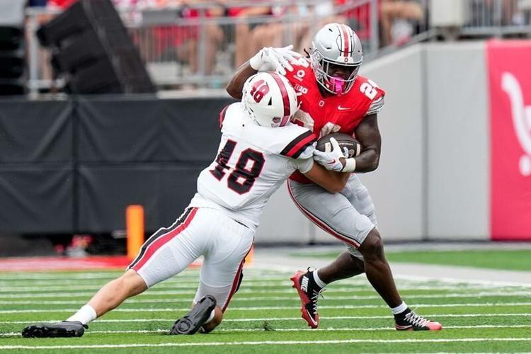 Ohio State Buckeyes running back Ja'kobi Jackson (24) runs the ball against Ball State Cardinals linebacker Sam Feeney (48) in the first half of the NCAA football game at Ohio Stadium on Sept. 5, 2026 in Columbus, Ohio.