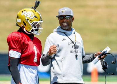 Head coach Eddie Robinson, Jr., works with quarterback Andrew Body (1) during an Alabama State University football scrimmage at ASU Stadium in Montgomery Ala., on Saturday August 16, 2025.