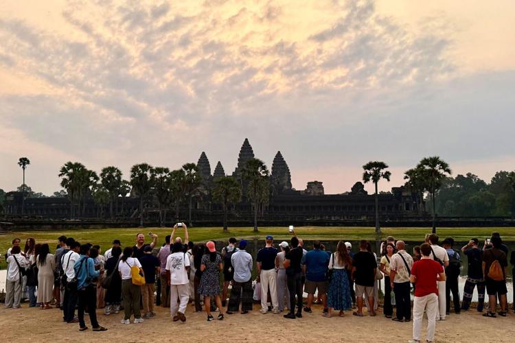 Sunrise at Angkor Wat temple, with tourists easily getting the shot they want as relatively few travellers head for Cambodia, due to conflict.