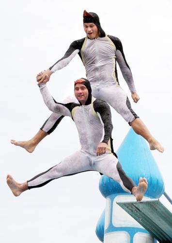 Two members of the Penguins of the Artic High Diving Show dive together during their show Tuesday afternoon during the Nebraska State Fair in Grand Island. (Independent/Barrett Stinson)