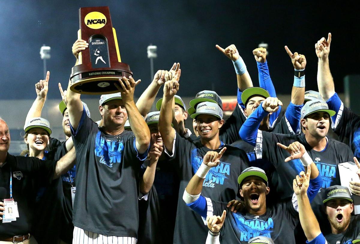 UCLA head coach John Savage holds up the championship trophy after defeating Mississippi State during the College World Series on June 25, 2013, at TD Ameritrade Park in Omaha, Nebraska.