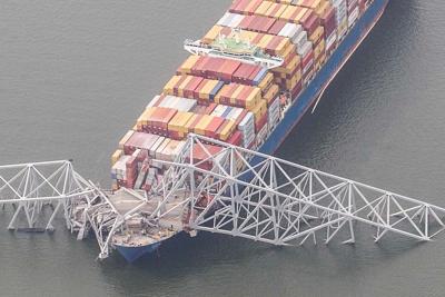 Remnants of the collapsed Francis Scott Key Bridge rest on the container ship Dali in Baltimore, Tuesday, March 26, 2024.