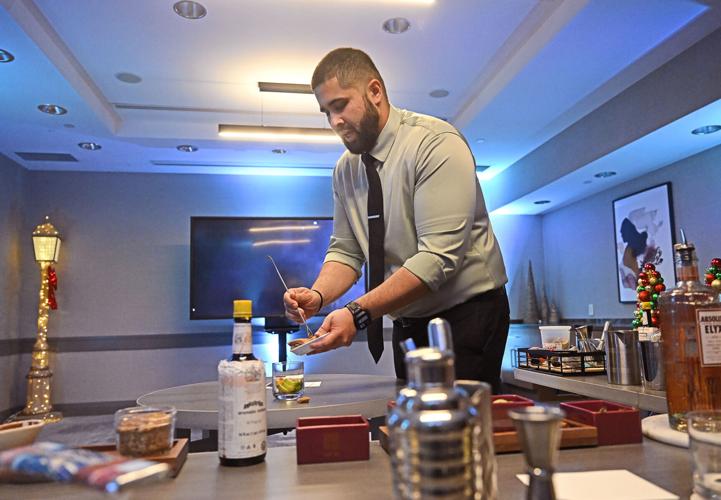 Bartender Thiago Leite pours brown sugar in his Caipi Vodka as The Fairmont Hotel gives a demo class of how to make 3 holiday cocktails on Sunday, Nov. 23, 2025, at The Fairmont Hotel in downtown Pittsburgh.