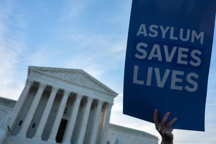 FILE PHOTO: Demonstrators gather for a vigil prior to arguments in Noem v. Al Otro Lado at the U.S. Supreme Court building in Washington (copy)