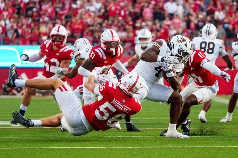 Sep 12, 2026; Lincoln, Nebraska, USA;  Bowling Green Falcons running back Ke'marion Baldwin (4) is dragged down by Nebraska Cornhuskers linebacker Pierce Mooberry (56) during the second quarter at Memorial Stadium.  Mandatory Credit: Dylan Widger-Imagn ...