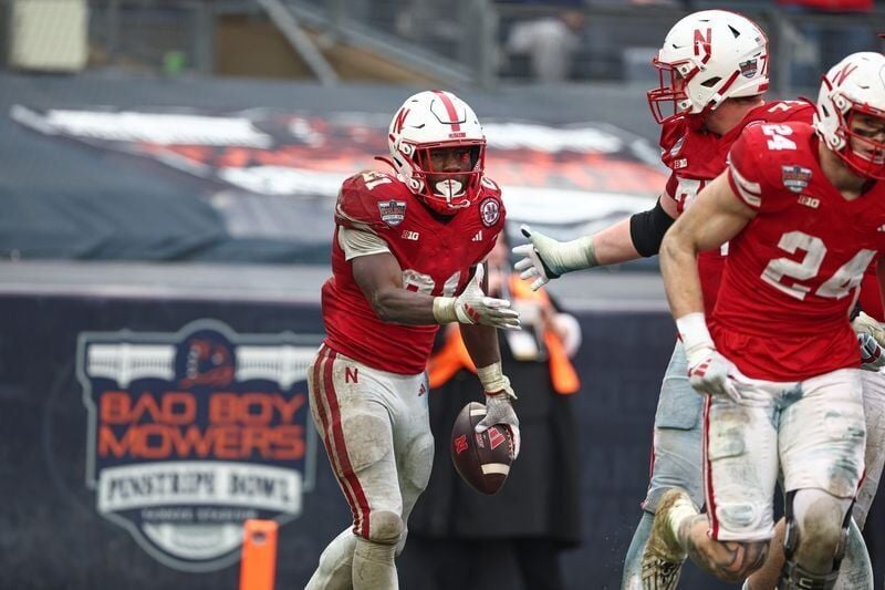 Dec 28, 2024; Bronx, NY, USA; Nebraska Cornhuskers running back Emmett Johnson (21) celebrates with teammates after a touchdown during the second half against the Boston College Eagles at Yankee Stadium. Mandatory Credit: Vincent Carchietta-Imagn Images