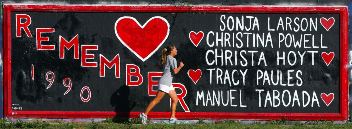 A University of Florida student jogs past a graffiti painted wall on 34th street in Gainesville, Florida, on Oct. 26, 2006.