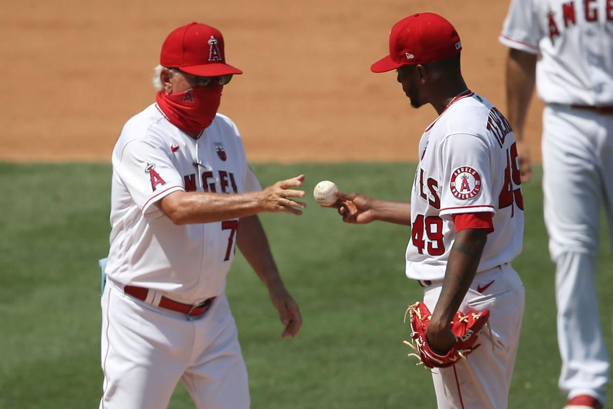 Manager Joe Maddon relieves Julio Teheran #49 of the Los Angeles Angels during the fourth inning of a game against the Los Angeles Dodgers at Angel Stadium of Anaheim on Aug. 16, 2020 in Anaheim, California.