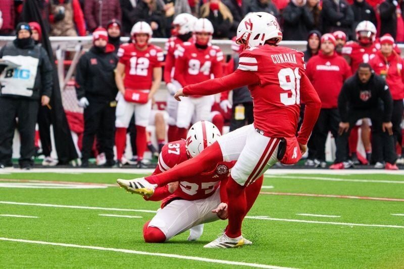 Nov 28, 2025; Lincoln, Nebraska, USA; Nebraska Cornhuskers kicker Kyle Cunanan (91) kicks a PAT against the Iowa Hawkeyes during the first quarter at Memorial Stadium. Mandatory Credit: Dylan Widger-Imagn Images