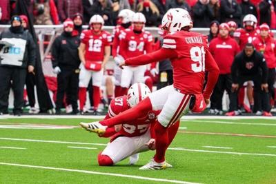 Nov 28, 2025; Lincoln, Nebraska, USA; Nebraska Cornhuskers kicker Kyle Cunanan (91) kicks a PAT against the Iowa Hawkeyes during the first quarter at Memorial Stadium. Mandatory Credit: Dylan Widger-Imagn Images