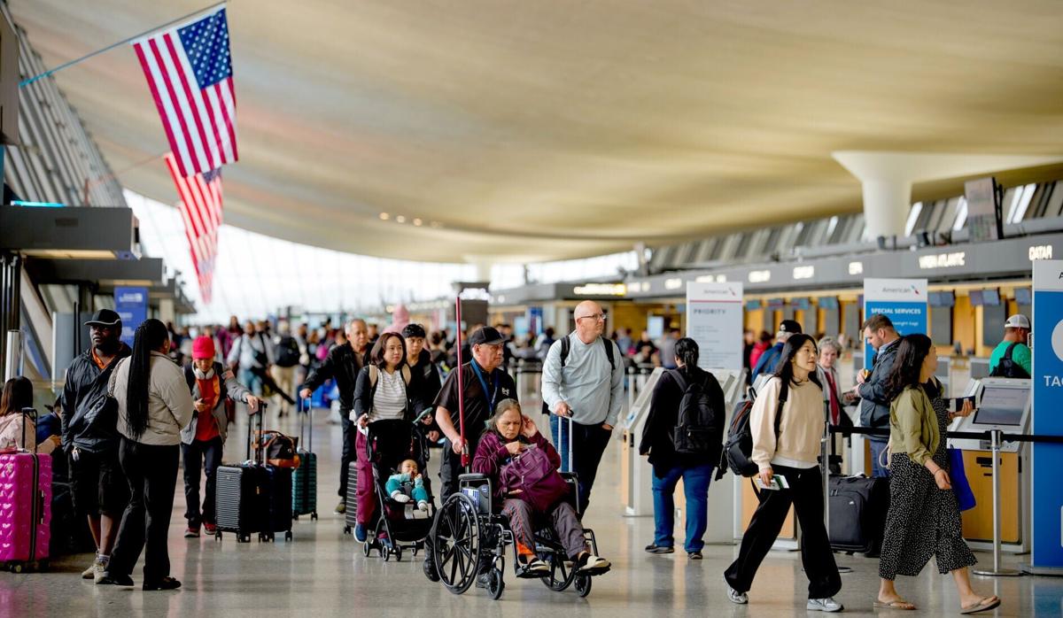 Travelers move through Washington Dulles International Airport on May 22, 2026 in Dulles, United States.