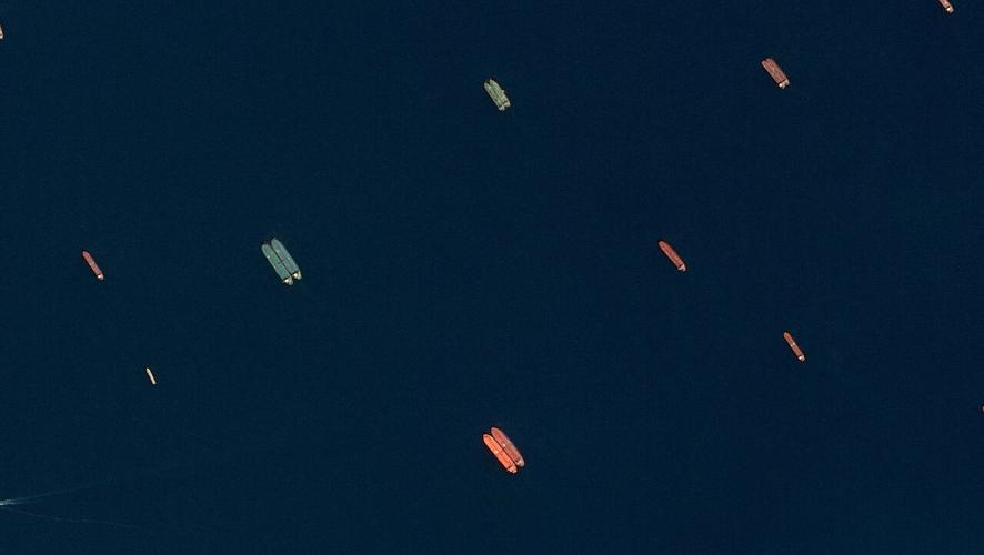 A satellite image of side-by-side ships at sea, off the coast of Sohar