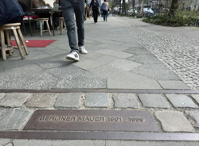 A marking on the ground shows where the Berlin Wall once cut through the heart of the city, dividing East and West Berlin.