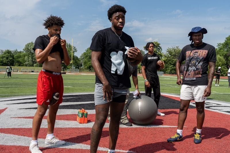 From left to right, Trae Taylor, 16, a quarterback at Carmel Catholic High School and a Nebraska commit in the class of 2027, Aidan Chiles, 19, a Michigan State University quarterback, Donald Tabron II, 16, a quarterback at Cass Technical High School, a...