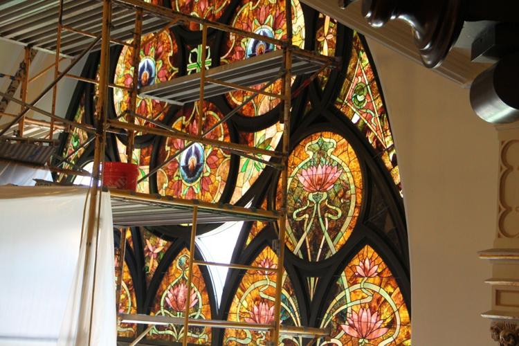 Installing Refurbished Stained glass on East window.JPG