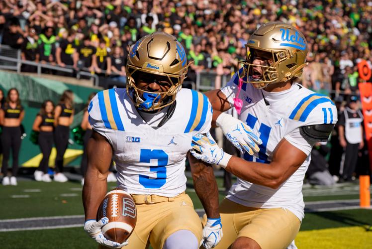 UCLA running back Wayne Knight, left, and wide receiver Landon Ellis celebrate a touchdown by Knight as the Oregon Ducks host