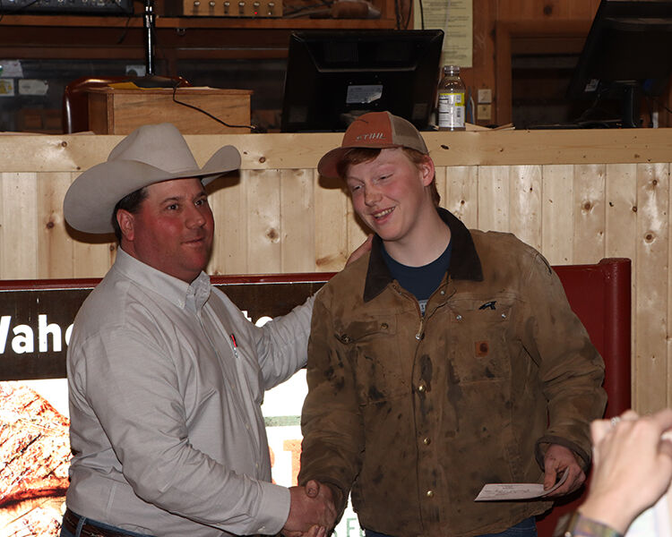 Rollover auction raises funds for young livestock producer