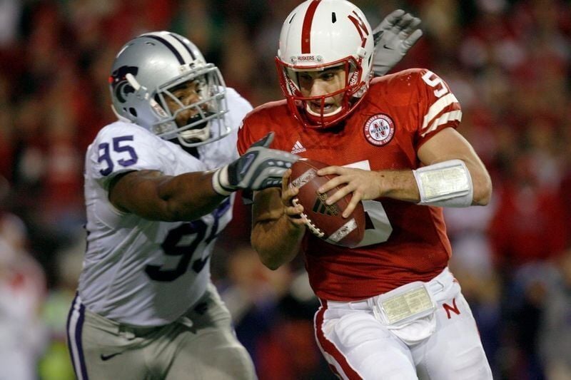 Nov 21, 2009; Lincoln, NE, USA; Nebraska Cornhuskers quarterback Zac Lee (5) is tackled by Kansas State Wildcats defender Jeffery Fitzgerald (95) during the second quarter at Memorial Stadium. Mandatory Credit: Bruce Thorson-USA TODAY Sports