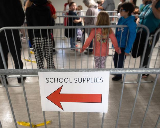 Families receive back-to-school supplies inside the Daffin Park Clubhouse in Panama City, Florida, August 1, 2026. The event was organized by the City's Department of Parks, Culture and Recreation. (Tyler Orsburn/Panama City News Herald)