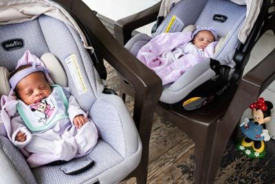 Three-week-old twins Jaliyah and Janiyah, born July 1 to two Detroit EMTs rest in their carseats on the porch as their mother Jessica Johnson, 31, speaks to media about the EMTs that delivered her babies in Detroit on Monday, July 21, 2025.