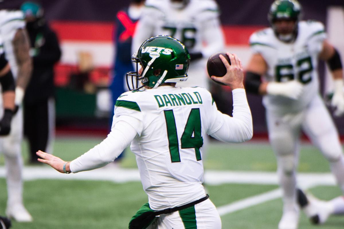 Sam Darnold #14 of the New York Jets makes a pass against the New England Patriots in the first half at Gillette Stadium on January 3, 2021, in Foxborough, Mass.
