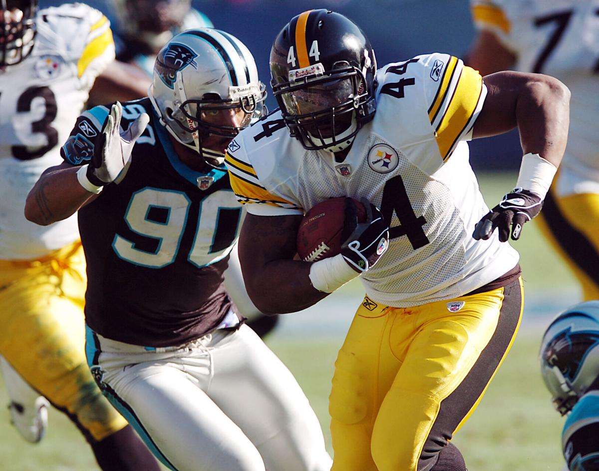 Pittsburgh Steelers running back Najeh Davenport gets past Carolina Panthers defender Julius Peppers at Bank of America Stadium in Charlotte, North Carolina, on December 17, 2006.