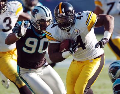 Pittsburgh Steelers running back Najeh Davenport gets past Carolina Panthers defender Julius Peppers at Bank of America Stadium in Charlotte, North Carolina, on December 17, 2006.