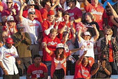 Nebraska fans celebrate after Nebraska's Hannah Camenzind (9) hits a home run during a NCAA super regional game between Tennessee and Nebraska at Sherri Parker Lee Stadium in Knoxville, Tenn., on May 23, 2025.
