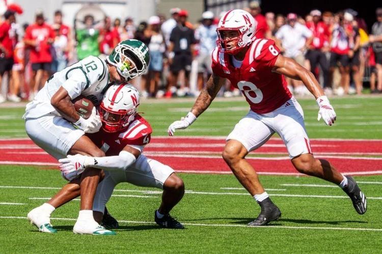 Sep 5, 2026; Lincoln, Nebraska, USA;  Ohio Bobcats wide receiver Eian Pugh (12) is tackled by Nebraska Cornhuskers defensive back Jamir Conn (4) during the second quarter at Memorial Stadium.  Mandatory Credit: Dylan Widger-Imagn Images