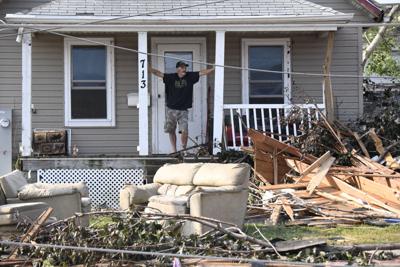 A man surveys damage at his home after a tornado ripped through parts of Menasha, Wisconsin, on July 28, 2026.