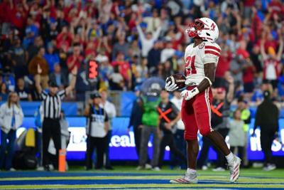 Nov 8, 2025; Pasadena, California, USA; Nebraska Cornhuskers running back Emmett Johnson (21) celebrates his touchdown scored against the UCLA Bruins during the first half at the Rose Bowl. Mandatory Credit: Gary A. Vasquez-Imagn Images
