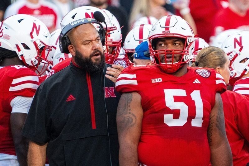 Sep 7, 2024; Lincoln, Nebraska, USA; Nebraska Cornhuskers assistant coach Donovan Raiola talks with offensive lineman Justin Evans (51) during the first quarter against the Colorado Buffaloes at Memorial Stadium. Mandatory Credit: Dylan Widger-Imagn Images