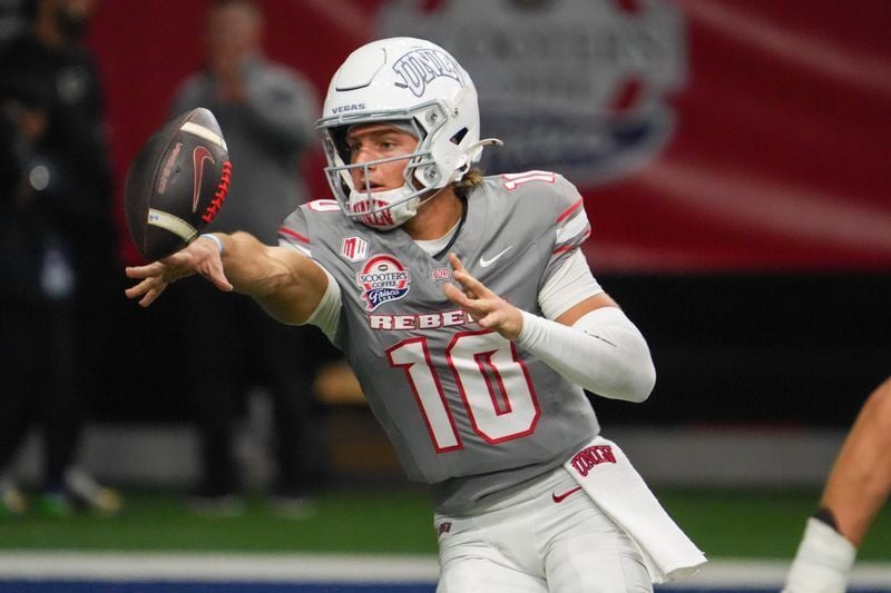 Dec 23, 2025; Frisco, TX, USA; UNLV Rebels quarterback Anthony Colandrea (10) pitches the ball against the Ohio Bobcats during the second half at the Ford Center at The Star. Mandatory Credit: Raymond Carlin III-Imagn Images
