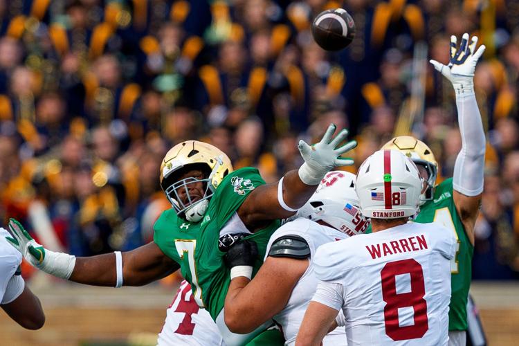 Notre Dame defensive lineman Francis Brewu (7) attempts to block a pass by Stanford quarterback Davis Warren (8) during a NCAA