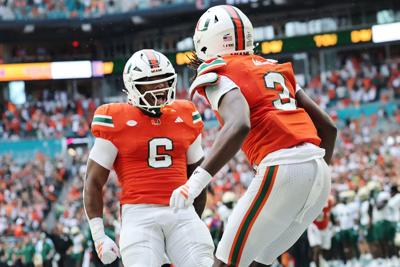 Joshua Moore of the Miami Hurricanes celebrates with Damari Brown following his reception for a touchdown against the South Florida Bulls during the first half at Hard Rock Stadium on Sept. 13, 2025, in Miami Gardens, Florida.