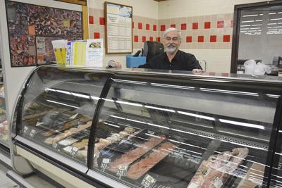 Longtime Econofoods meat manager hanging up apron