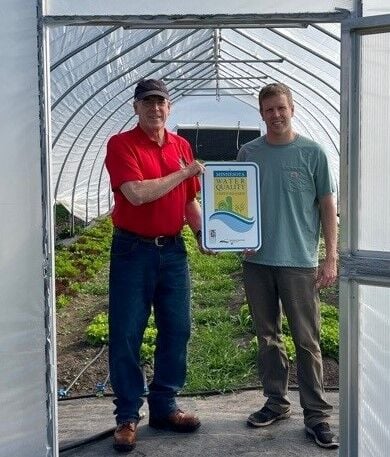 MAWQCP Area Specialist Jim Lahn (left) presenting the Water Quality Certified Farm sign to Andrew Spicola last fall.