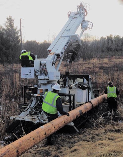 A crew from Lake Country Power put an osprey nest platform on a new pole.