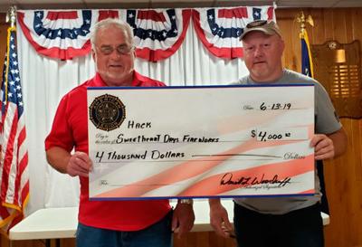 Legion Post 202 Gambling Manager Dave Woodruff (left) hands the “big” check to Hackensack Chamber President Chuck Trosen.