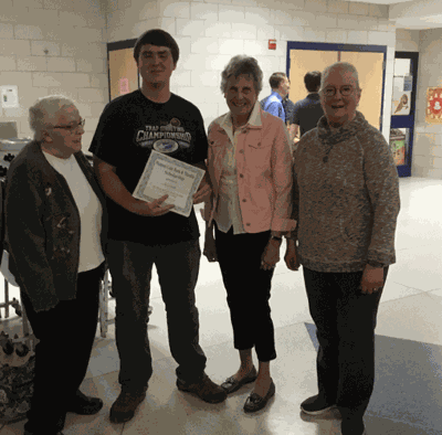 Pictured is Jacob Radke accepting the scholarship from (left) Margaret Zieffler, President Joni Kumpula and Gracee Rudkin.