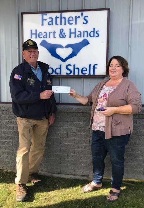 VFW Post Commander Jerry Varner presents a 200 check to Noreen