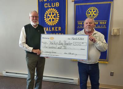 Rotary President Dan Eikenberry (left) hands the check to Theater Director Fred Rogers.