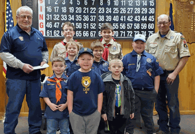 Post 202 Gambling Manager David Woodruff (left) presented the check to the Scouts and Cub Master Matt Shamp (right).
