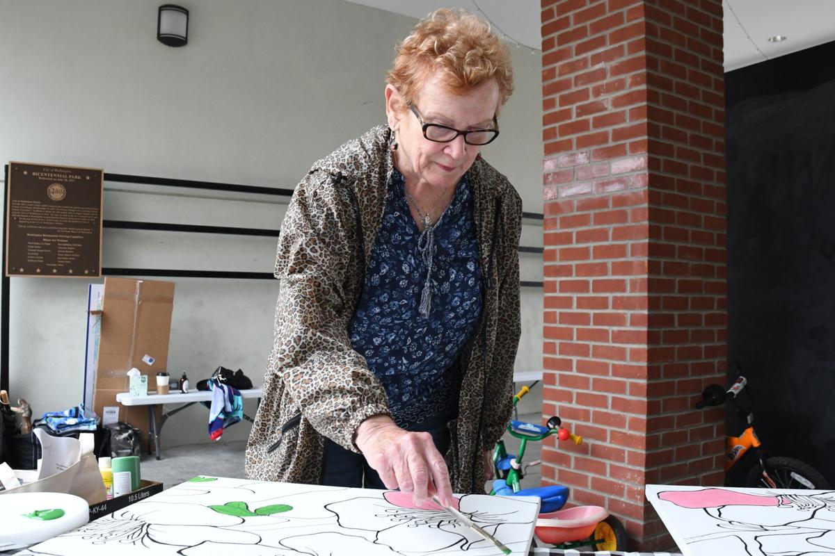 Karen Stone, from Texas, paints on the community mural. Mother of Cindy Barber, Washington.JPG