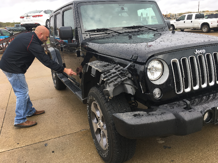 Kevin Schwarzhoff with deer-damaged Jeep