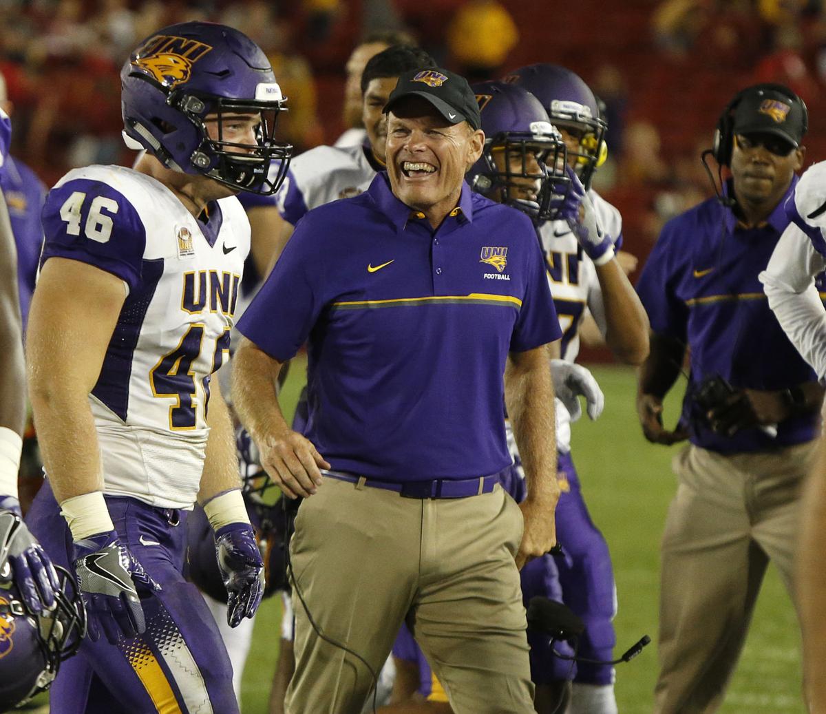 Northern Iowa head coach Mark Farley, center, congratulates his son Jared Farley, left, on his interception in the final seconds that sealed the Panthers' 25-20 win at Iowa State Saturday night. (Matthew Putney/Courier Photo Editor)