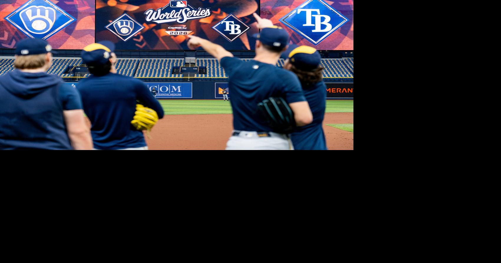 Milwaukee Brewers players point towards a fly ball during a workout and ...