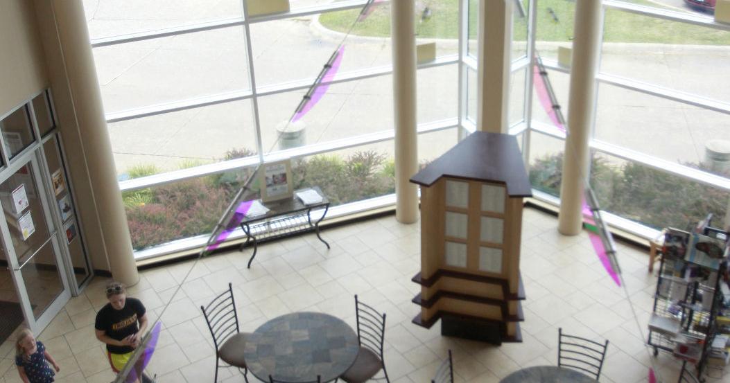 Cedar Falls library lobby artwork being installed