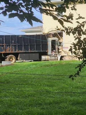 Loaded dump truck crashes into Johnson Creek home